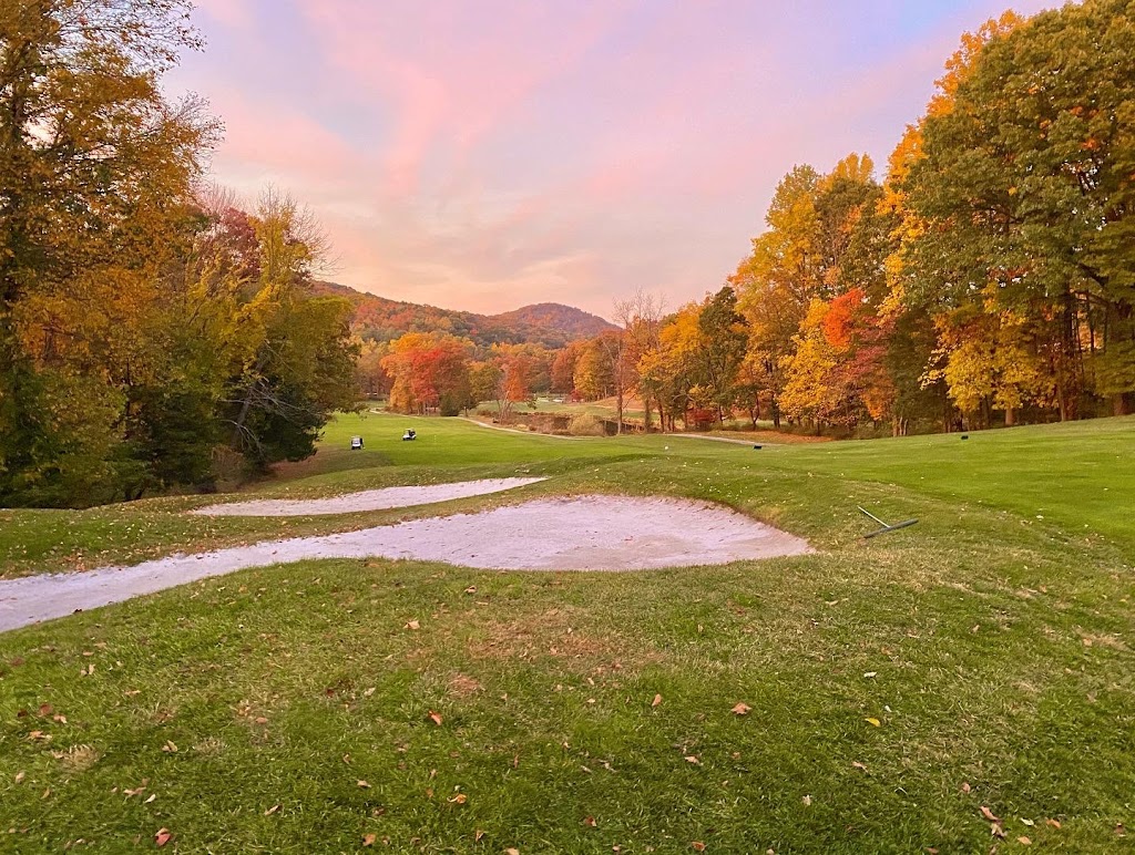Panoramic view of a lush green golf course at Sunset Valley Golf Course. Smooth