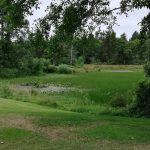 Panoramic view of a lush green golf course at Surfside Golf Course. Smooth