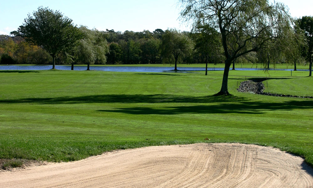 Panoramic view of a lush green golf course at Swan Lake Golf Club. Smooth