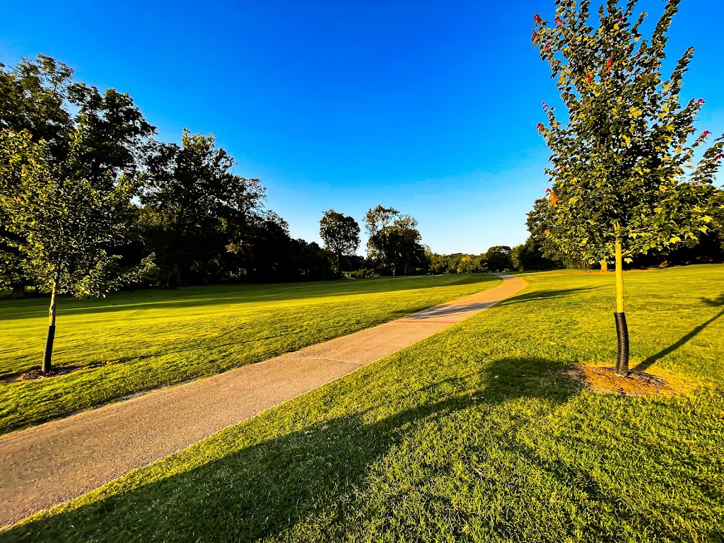 Panoramic view of a lush green golf course at Swan Lake Golf Course. Smooth