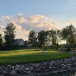 Panoramic view of a lush green golf course at Sycamore Hills Golf Club. Smooth