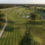 Panoramic view of a lush green golf course at Sycamore Ridge Golf Club. Smooth
