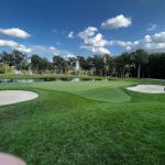 Panoramic view of a lush green golf course at TPC Deere Run. Smooth