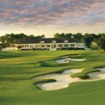 Panoramic view of a lush green golf course at TPC Myrtle Beach. Smooth
