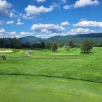 Panoramic view of a lush green golf course at Taconic Golf Club. Smooth
