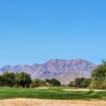 Panoramic view of a lush green golf course at Talking Stick Golf Club. Smooth
