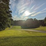 Panoramic view of a lush green golf course at Tallwood Country Club LLC. Smooth