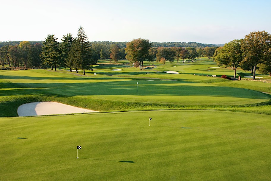 Panoramic view of a lush green golf course at Tamarack Country Club. Smooth