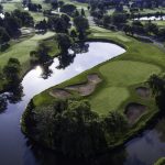 Panoramic view of a lush green golf course at Tamarack Golf Club. Smooth