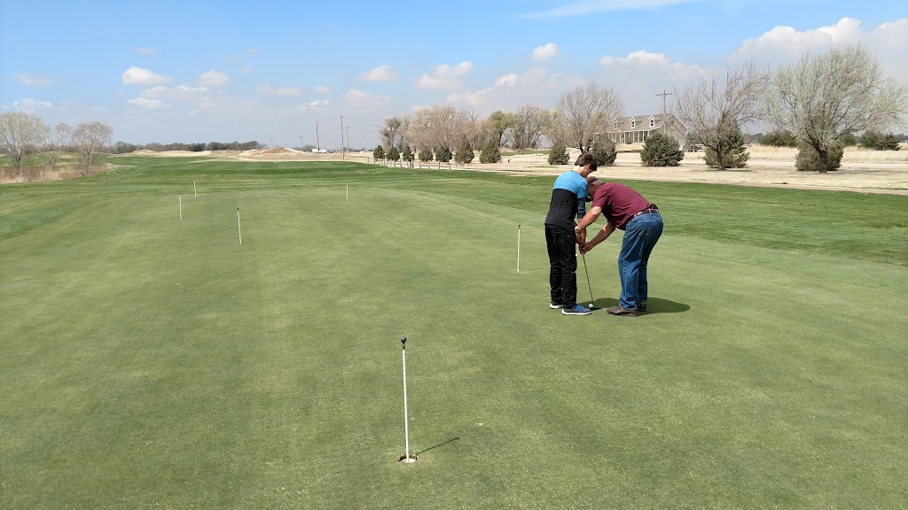 Panoramic view of a lush green golf course at Tamarisk Golf Course. Smooth