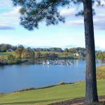 Panoramic view of a lush green golf course at Tanasi Golf Course. Smooth