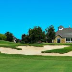 Panoramic view of a lush green golf course at Tangle Ridge Golf Course. Smooth