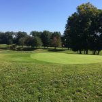 Panoramic view of a lush green golf course at Tanglewood Public Golf Course & Driving Range. Smooth