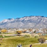 Panoramic view of a lush green golf course at Tanoan Country Club. Smooth