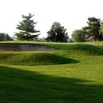 Panoramic view of a lush green golf course at Tara Hills Golf Course. Smooth