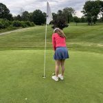 green grass with the flag in the hole.
