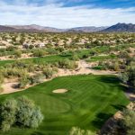 Panoramic view of a lush green golf course at Tatum Ranch Golf Club. Smooth