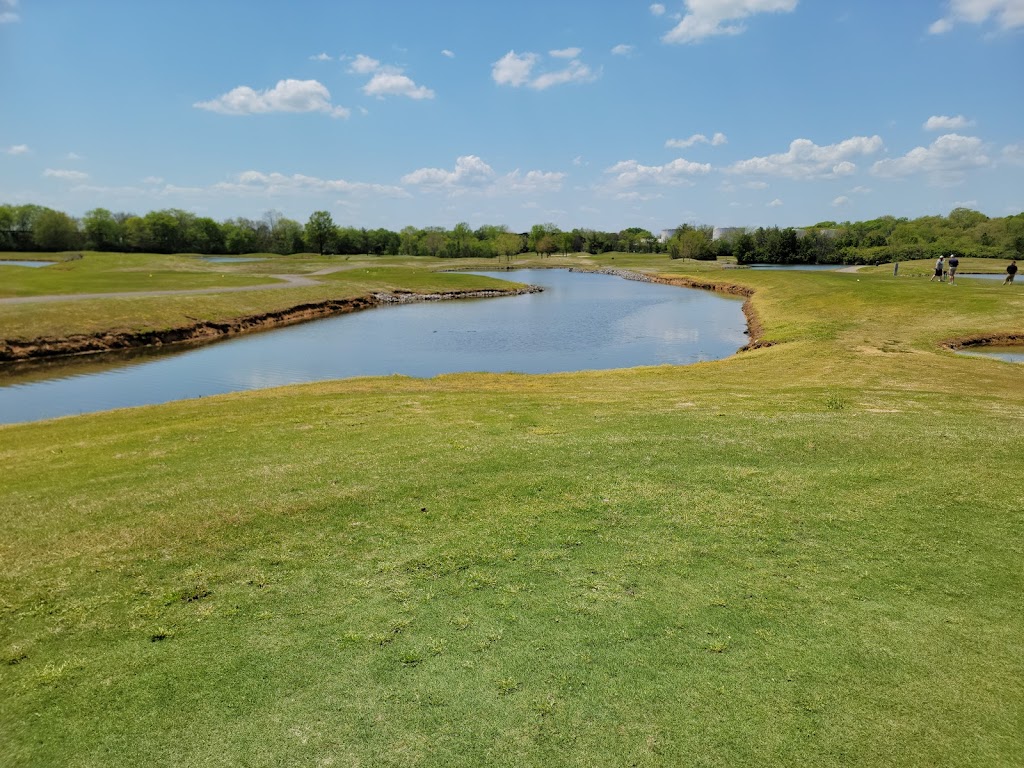 Panoramic view of a lush green golf course at Ted Rhodes Golf Course. Smooth