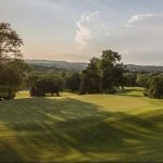Panoramic view of a lush green golf course at Temple Hills Country Club. Smooth