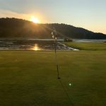 green grass with the flag in the hole.