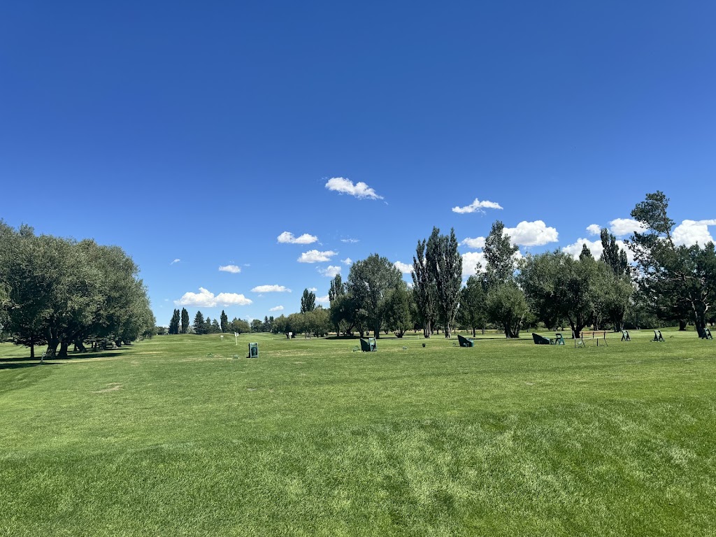 Panoramic view of a lush green golf course at Teton Lakes Golf Course. Smooth