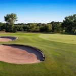 green grass with the flag in the hole.