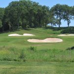 green grass with the flag in the hole.