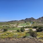 Panoramic view of a lush green golf course at The 500 Golf Club at Adobe Dam Regional Park. Smooth