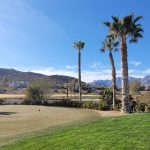 Panoramic view of a lush green golf course at The Arroyo Golf Club. Smooth