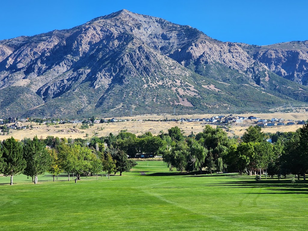 Panoramic view of a lush green golf course at The Barn Golf Course. Smooth
