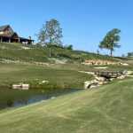 Panoramic view of a lush green golf course at The Battlefield Par 3 Course at Shangri-La. Smooth