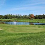 Panoramic view of a lush green golf course at The Bear Golf Course. Smooth