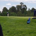 green grass with the flag in the hole.
