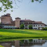 Panoramic view of a lush green golf course at The Broadmoor Golf Club. Smooth