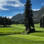 Panoramic view of a lush green golf course at The Broadmoor Golf Club. Smooth