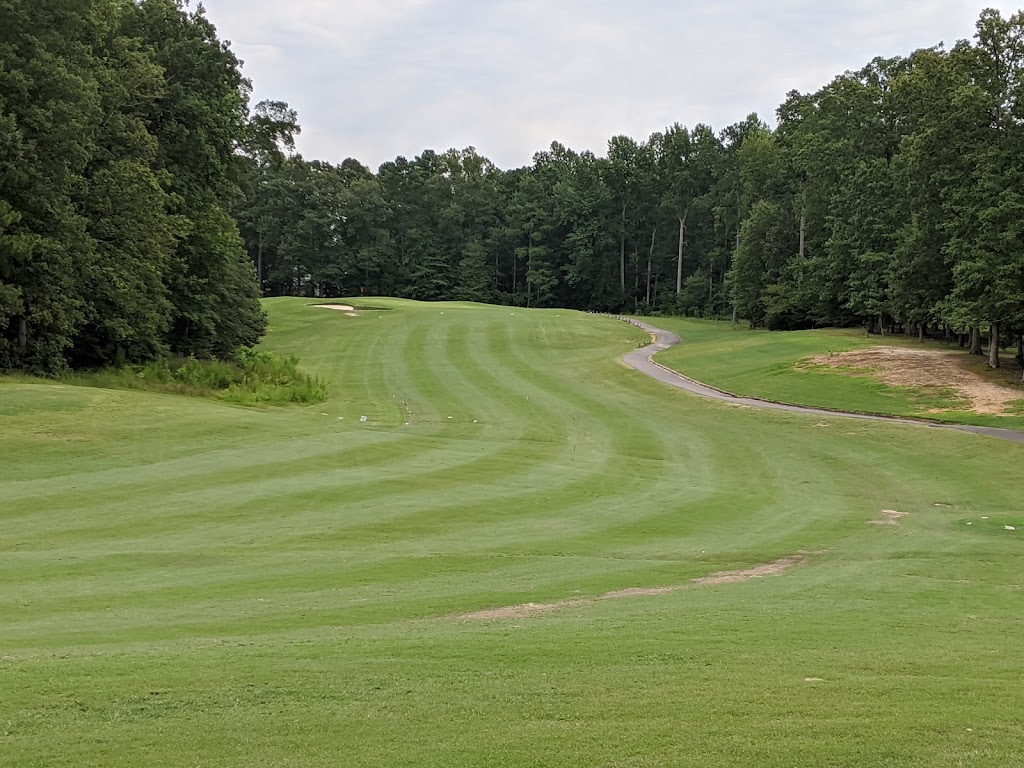 Panoramic view of a lush green golf course at The Brookwoods Golf Club. Smooth