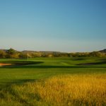 Panoramic view of a lush green golf course at The Buckhorn Golf Course. Smooth