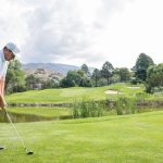 Panoramic view of a lush green golf course at The Canyon Club at Four Hills. Smooth