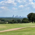 Panoramic view of a lush green golf course at The Canyons at Blackjack Ridge. Smooth