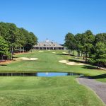 Panoramic view of a lush green golf course at The Chateau Elan Golf Club. Smooth