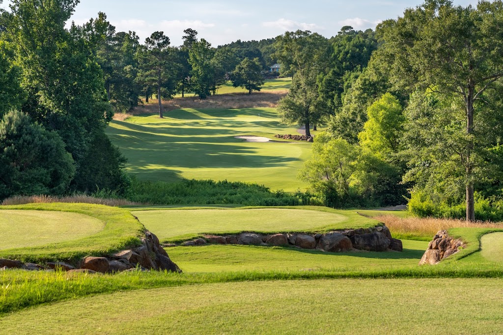 Panoramic view of a lush green golf course at The Chimneys Golf Course. Smooth