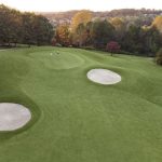 Panoramic view of a lush green golf course at The Club At Brookstone. Smooth