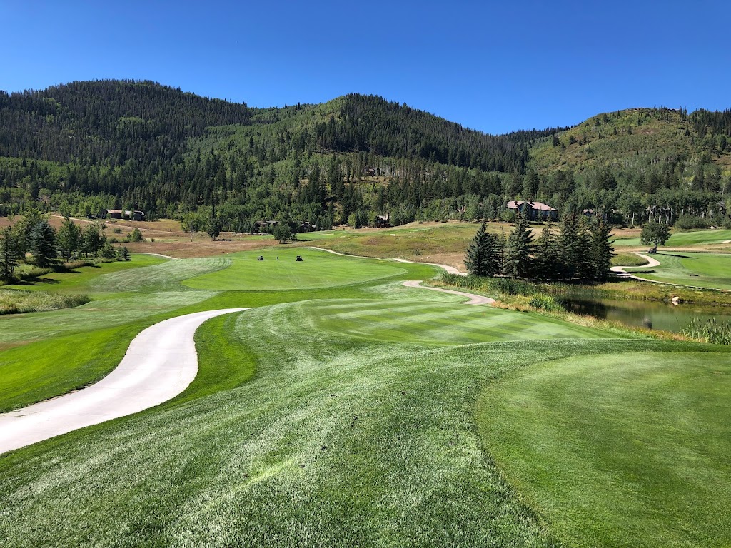 Panoramic view of a lush green golf course at The Club At Cordillera - Mountain Course. Smooth