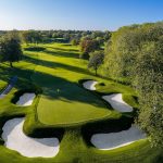 Panoramic view of a lush green golf course at The Club at Golden Valley. Smooth