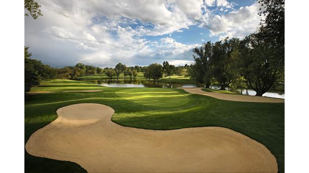Panoramic view of a lush green golf course at The Club at Inverness. Smooth