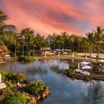 Panoramic view of a lush green golf course at The Club at Kukui`ula. Smooth