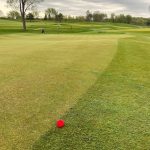 green grass with the flag in the hole.