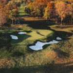 Panoramic view of a lush green golf course at The Club at Lac La Belle. Smooth