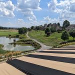 Panoramic view of a lush green golf course at The Club at Nevillewood. Smooth