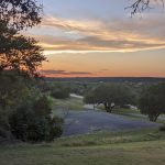 Panoramic view of a lush green golf course at The Club at Rebecca Creek. Smooth
